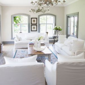 a big clean and tidy living room with white couches
