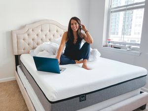 woman sitting on bed with Lull mattress, 