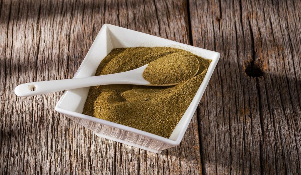 Ground Kratom powder in white bowl